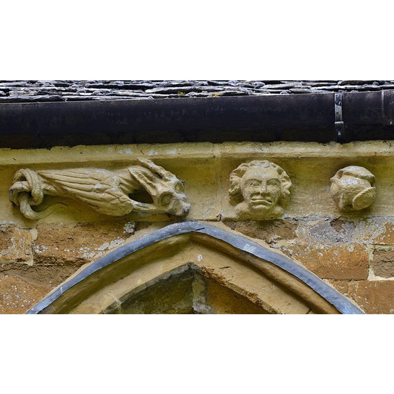Source caption: "Hanwell, St. Peter's Church: South frieze, ca. 1340: Head and bizarre winged creature with knotted tail" -- a detail of one of the many frieze figures and details on the exterior of this church