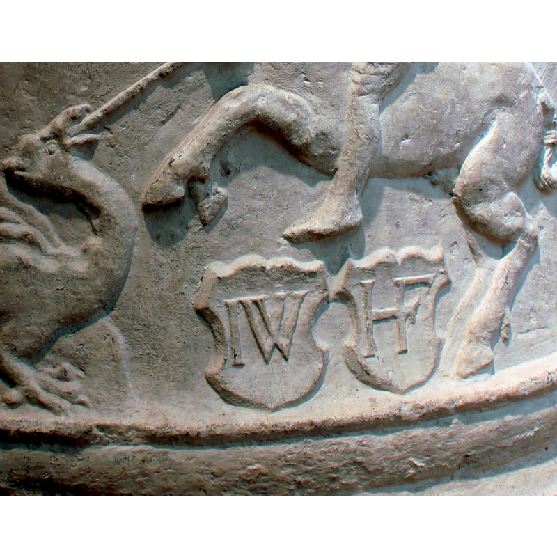 the St George and dragon scene is complemented by a kneeling figure on the cloud that appears to stem from the dragon's back, and by two shields chaged with sets of initials, below the horse