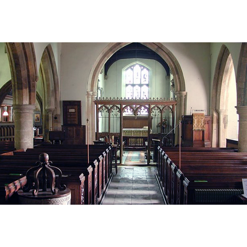 with a partial view of the re-carved font and its cover in the foreground, left side