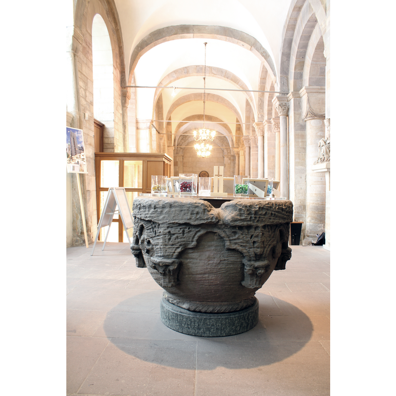 this is the side with the worst damage to the upper rim, a relic from an old font-cover anchor