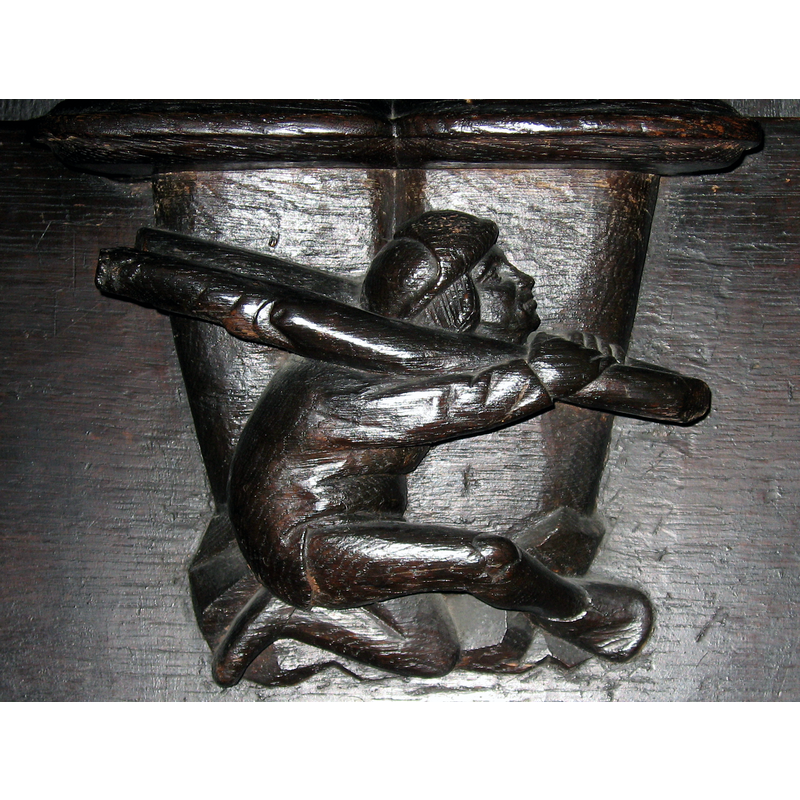 Source caption: "Marienkirche Dortmund, Cappenberger Chorgestühl (~1520), Miserikordien mit symbolischer Darstellung des Ehebrechers in der Gabel des Schandprangers".