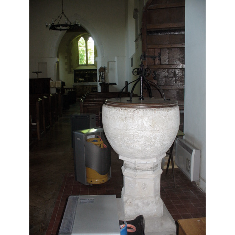 Source caption: "Saxon font and view towards the east window inside 13th century St Swithun's Church at Combe in the West Berkshire Downs."