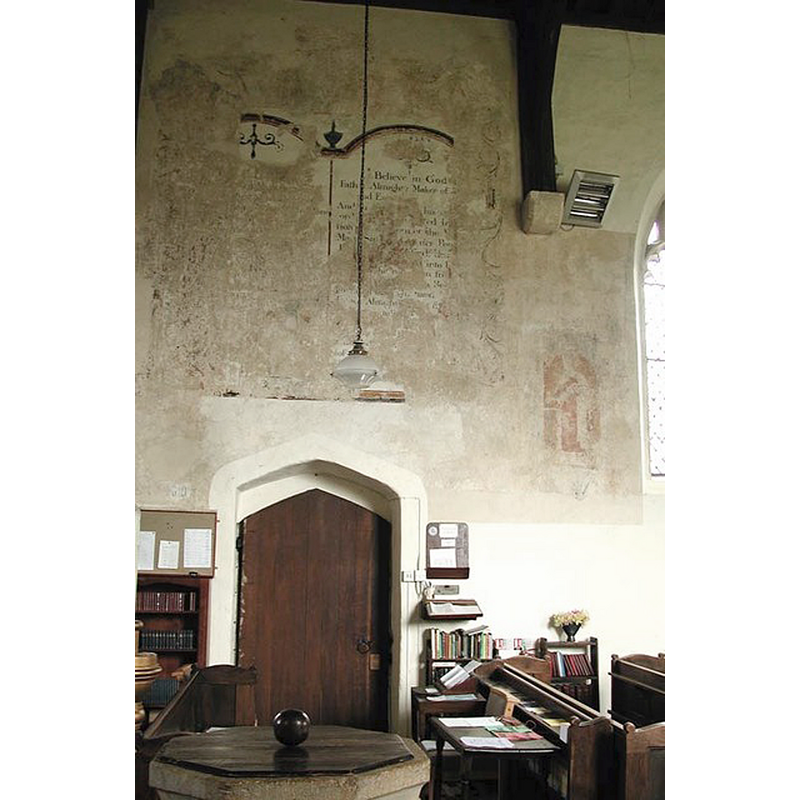 at the back, the wall paintings above the south entranceway; the top of the font and cover visible in the foreground