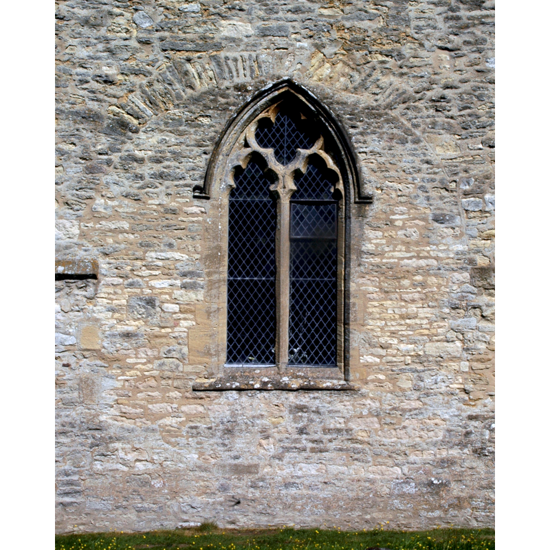 Source caption: "Decorated Gothic window in blocked late Saxon tower arch at the west end of the Church of England parish church of St Mary, North Leigh".