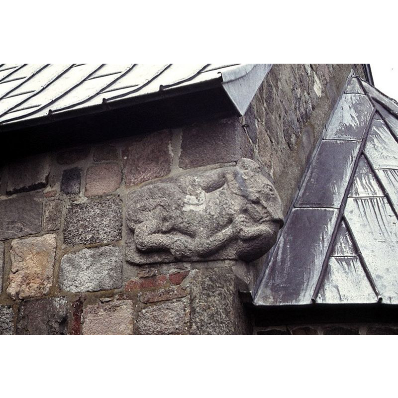 a man-eating lion [the front paws hold the man's arms and the mouth devours the man's head] at the top southeast corner where the chancel meets the apse