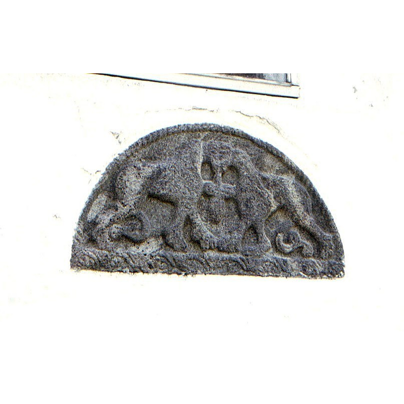 the tympanum of the former south portal is now built into the west wall of the tower -- bi-corporal lions, as found also on the font sides