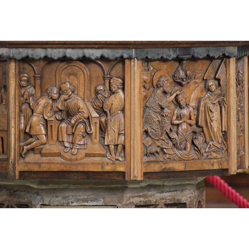 the modern wooden font -- the panel on the right of the image shows the Baptism of Christ
