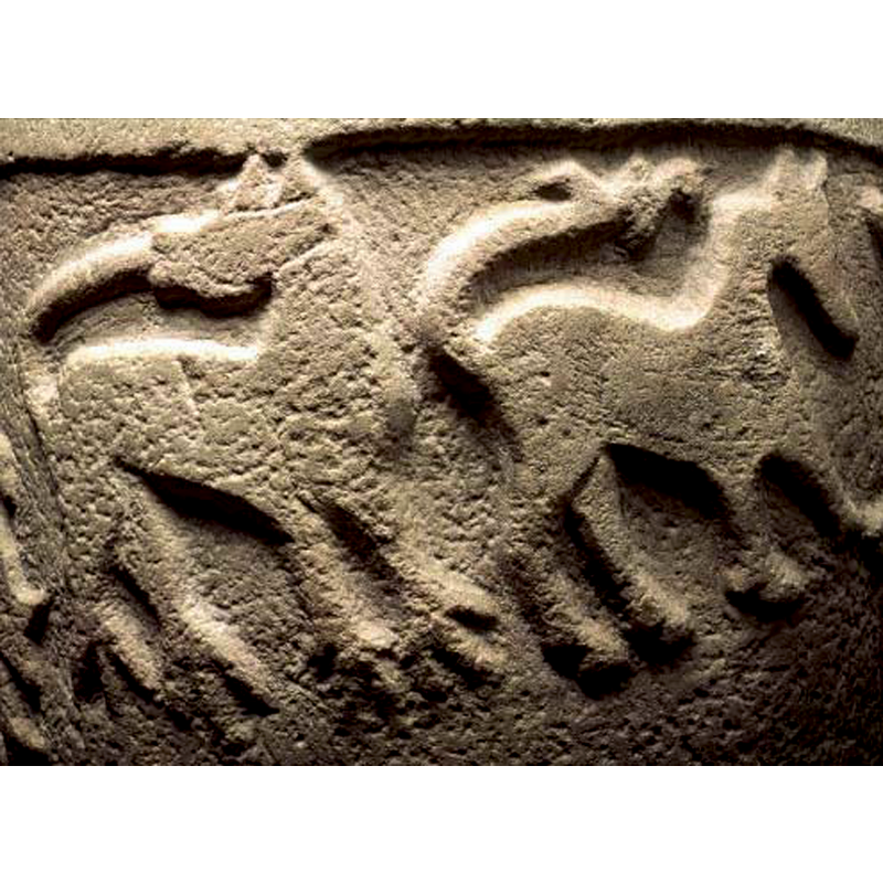 the one on the left is surely a lion, given its position, the tail, the claws...; the one on the right appears to be an ungulate, perhaps a horse