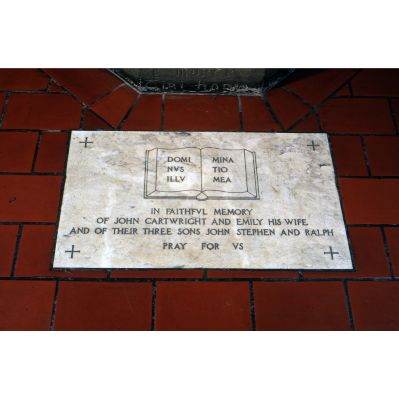 dedication plaque by the foot of the font