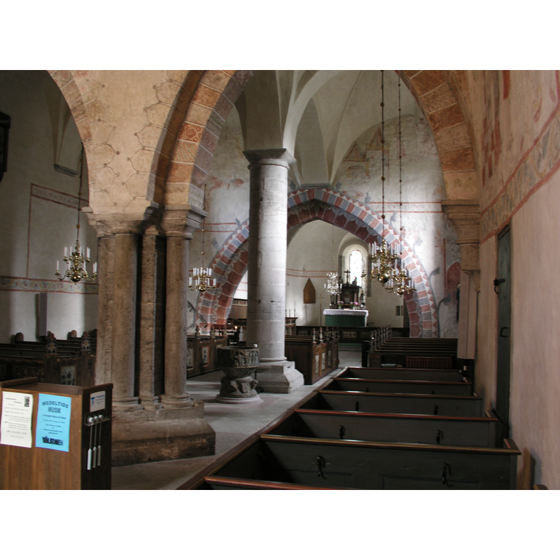with a view of the old font and the painted chancel arch