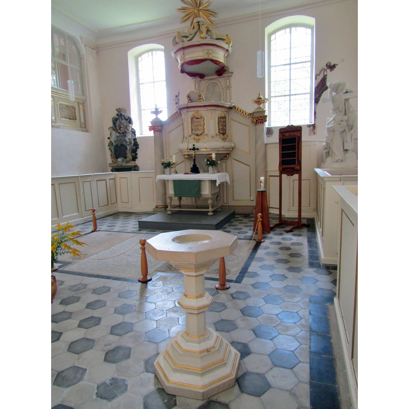 the modern font at the east end of the nave