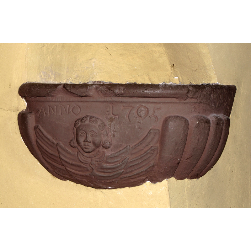 a 1705 holy-water stoup in the re-built church