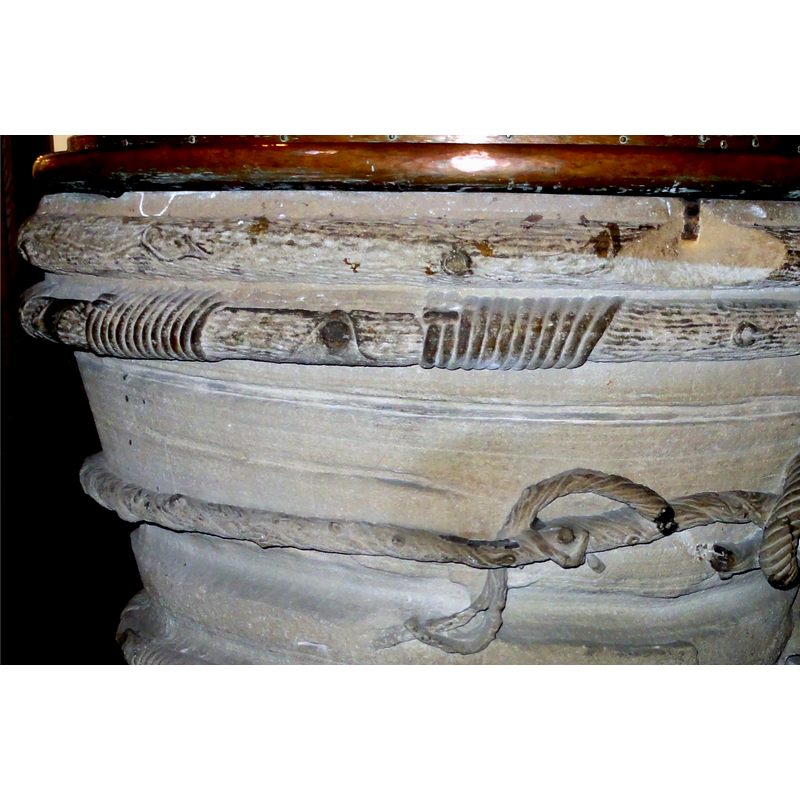 of the three ropes that surround the basin the top and the bottom ones have the knotted areas typical of the representation of a Franciscan cingulum in fonts