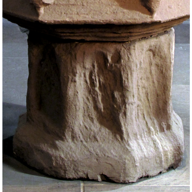 the font in the Catholic area of the interior: the whole of the stem is very eroded; there may have been figures and or scenes in the arches