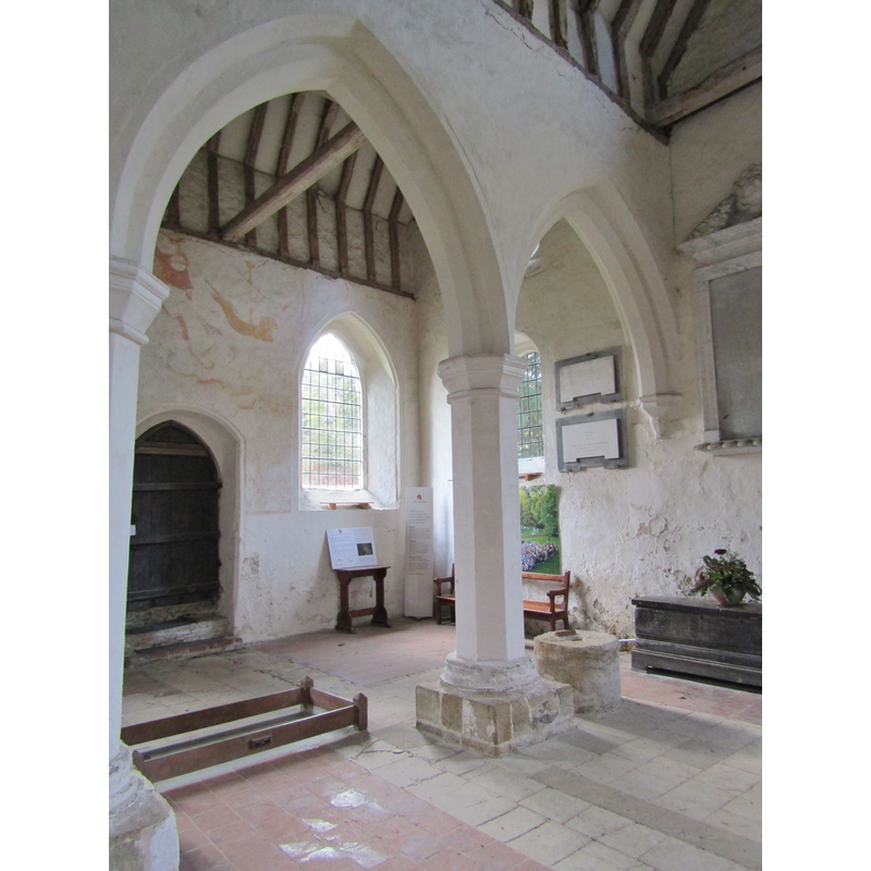 the interior of the old redundant church, showing the base of the old font, next to the pillar