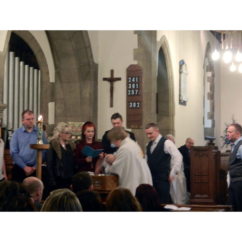 it is obviously the modern wooden font that is in use for baptisms now