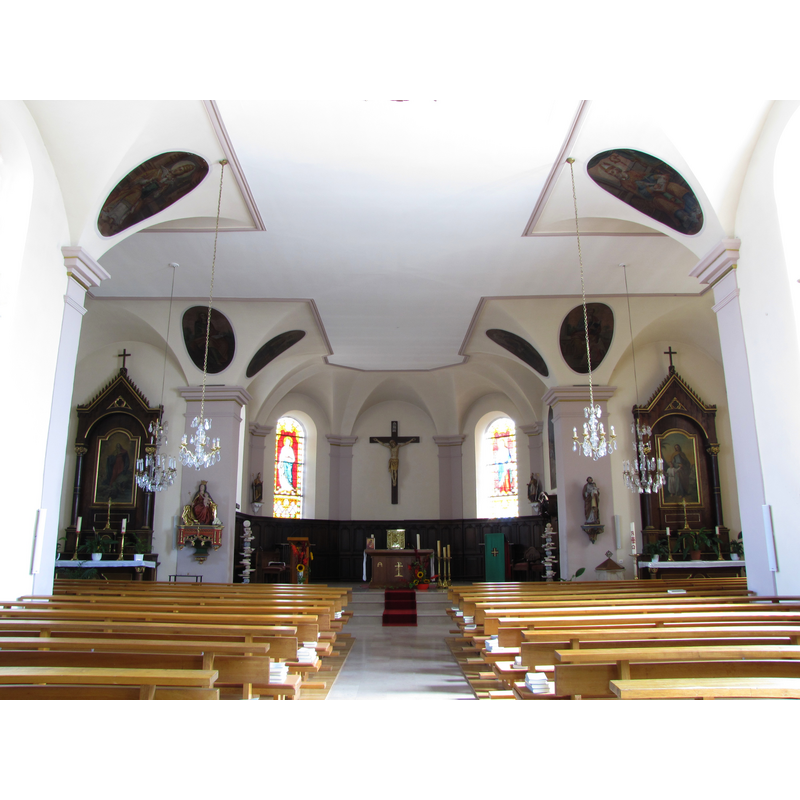 the top of the font and its cover are visible at the far [east] end, behind the tight [south] bank of benches, by the south auxiliary altar