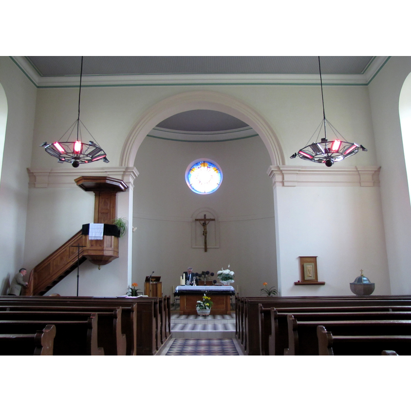 the stone font is partially visible in the right [southeast] corner of the nave