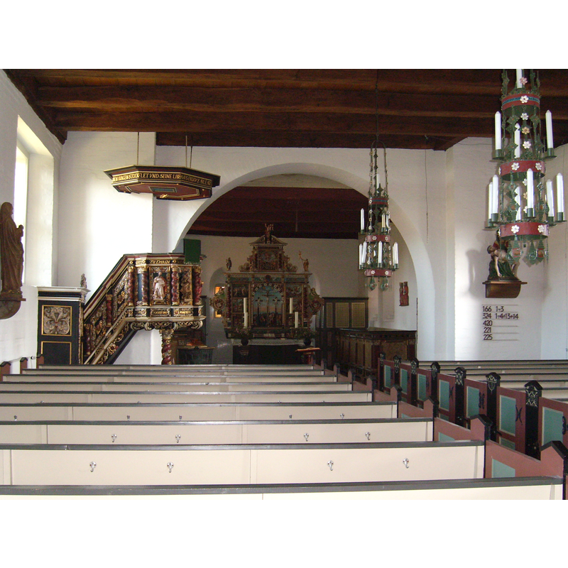 the font is discernible at the far [east] end, left [north] side, to the left of the altar