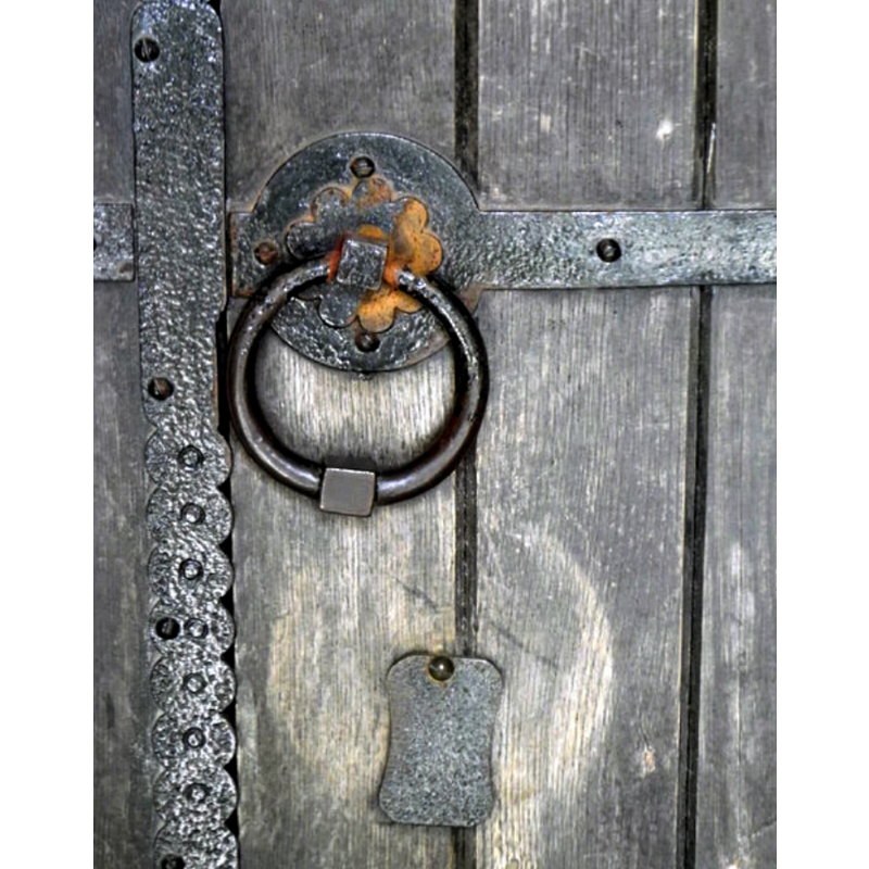 Source caption: "The Church of St John the Baptist. This is the handle and lock to the south door of the church."