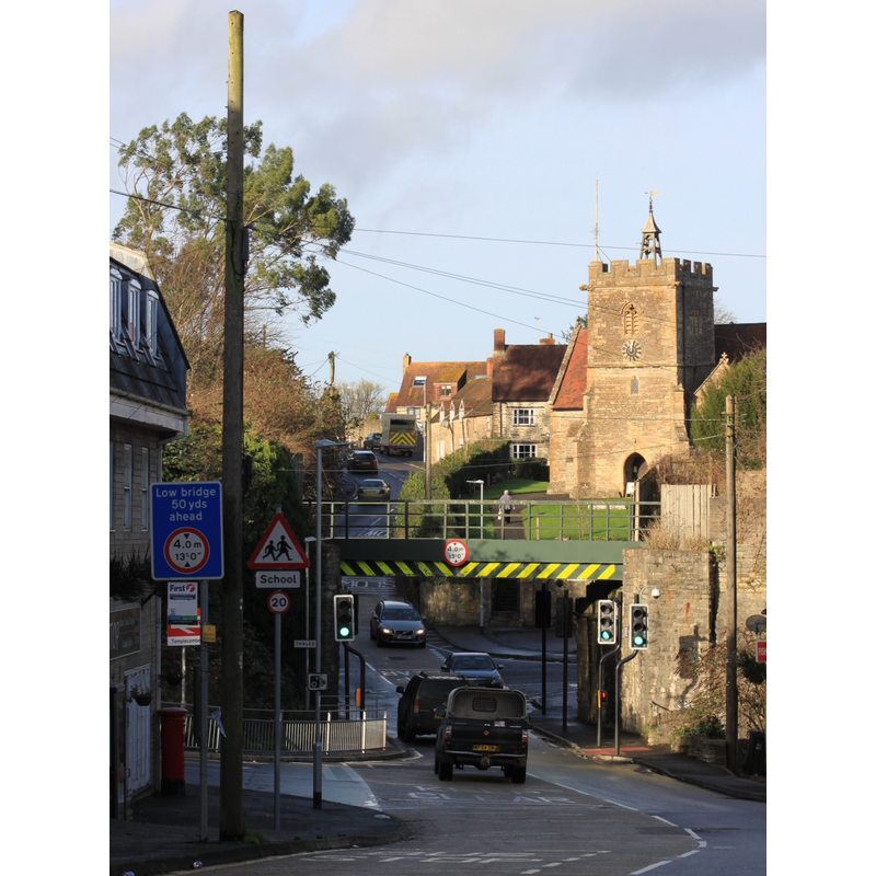 Source caption: "Looking north towards St Mary's church in Templecombe, Somerset. The bridge carries the Exeter to Salisbury railway line; the railway station is immediately to the left of this."