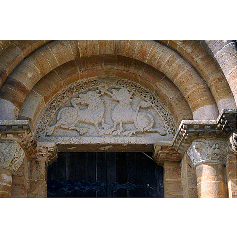 Source caption: "Milborne Port: tympanum in south doorway. In Ham stone. Featuring two Celtic-style animals; possibly dragons?"