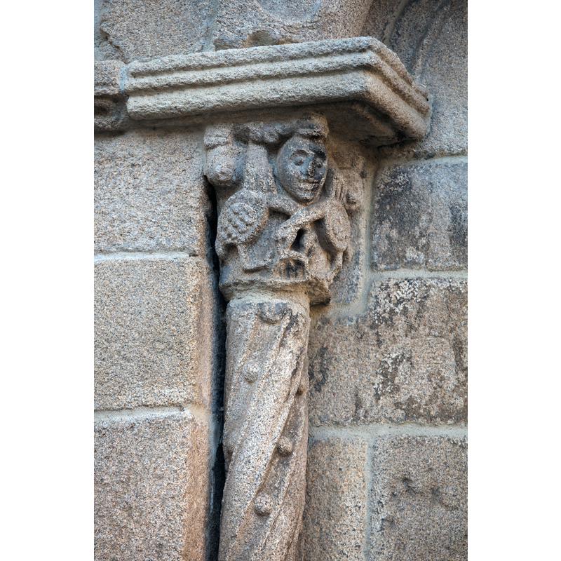 figural capital and patterned column on one of the apse windows