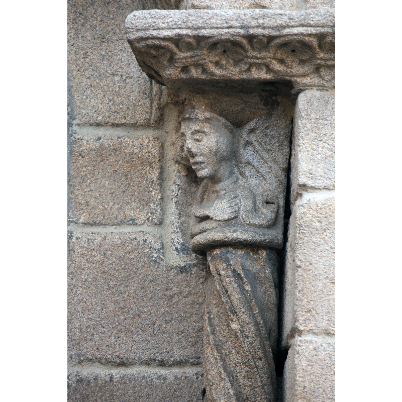 figural capital and patterned column on one of the apse windows