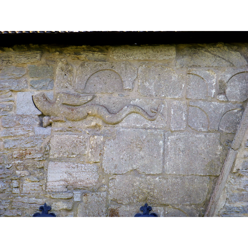 located above and to the left of the southwest [nave] portal
