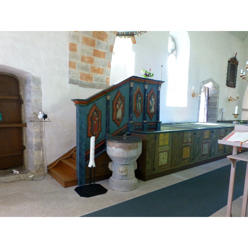 toward the east end of the church interior, south side, by the pulpit and the southeast portal