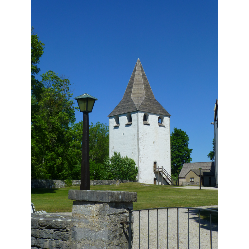 the detached tower to the west of the church is what remains of the original Romanesque church here; some elements of the old church were integrated into the present church, a late-13thC Gothic building