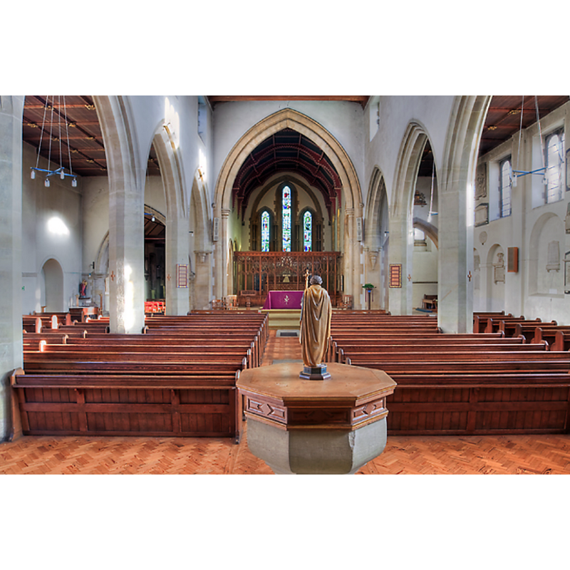 the modern font and cover in the foreground, at the west end of the nave