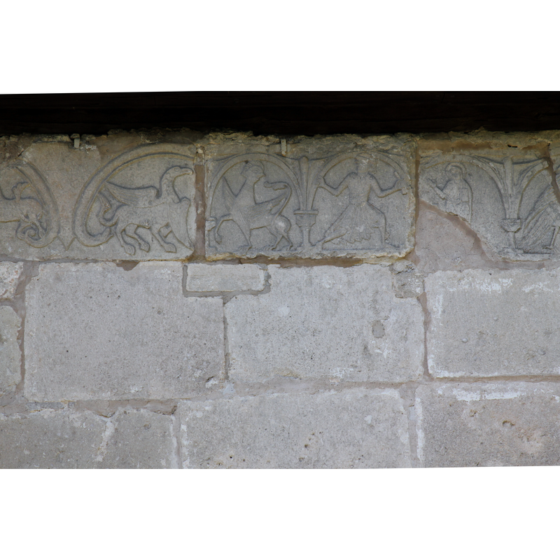 on the outer wall of the chancel, south side, right beneath the roof line