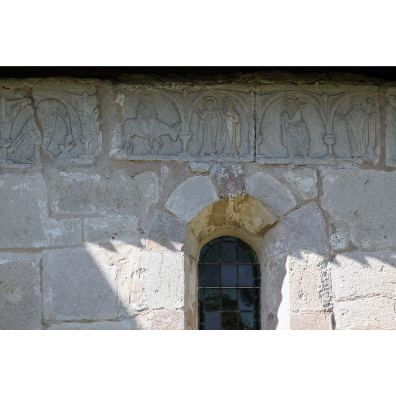 on the outer wall of the chancel, south side, right beneath the roof line