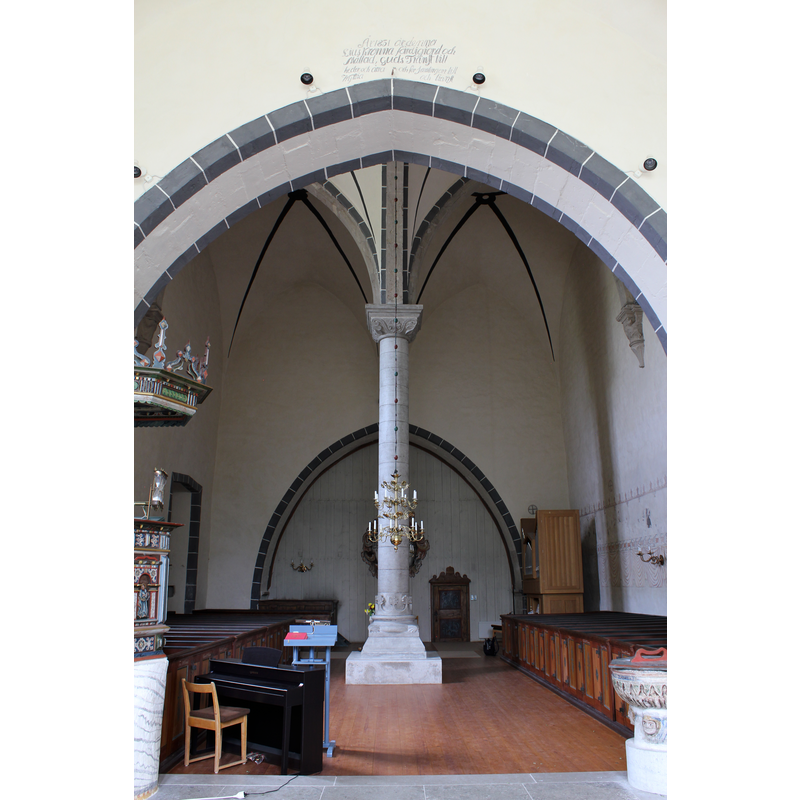 the font partially visible at the north [right] end of the chancel arch