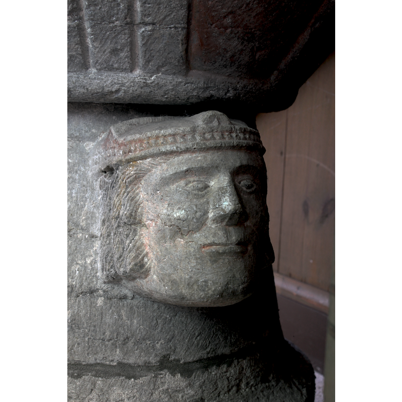 no facial hair but wearing long hair to the jowl -- on the west-northwest side of the base