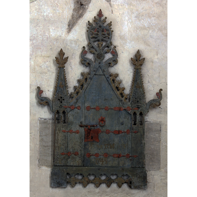 located on the east wall of the chancel to the south of the altar