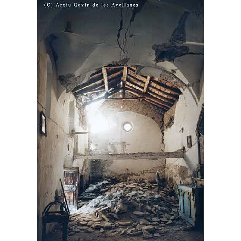 the interior of the church before the 2011 restoration -- the stoup is visible on the left, wall-mounted by the south doorway; the font was probably buried in the rubble at the time