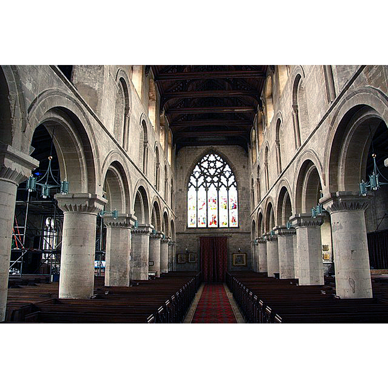 Source caption: "Looking west in St.Mary's nave, with 7-bay Norman arcades c1175, towards the much-restored 14th century west window with reticulated tracery".