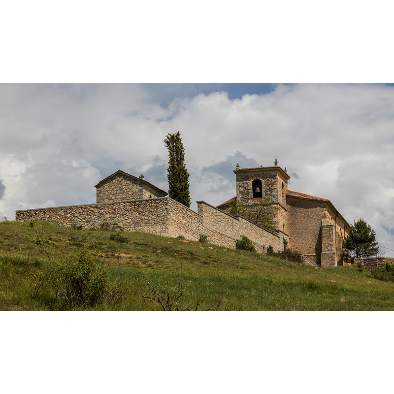 the walled enclosure in the foreground is probably the village cemetery