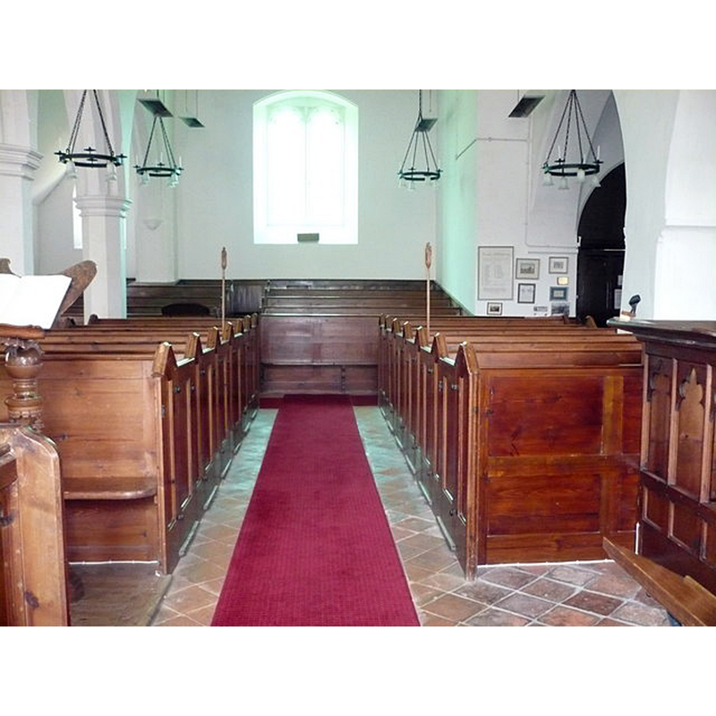 Source caption: "The nave of the church of St. Peter & St. Paul, Newnham. Looking west at the box pews and the unusual stepped pews at the western end."
