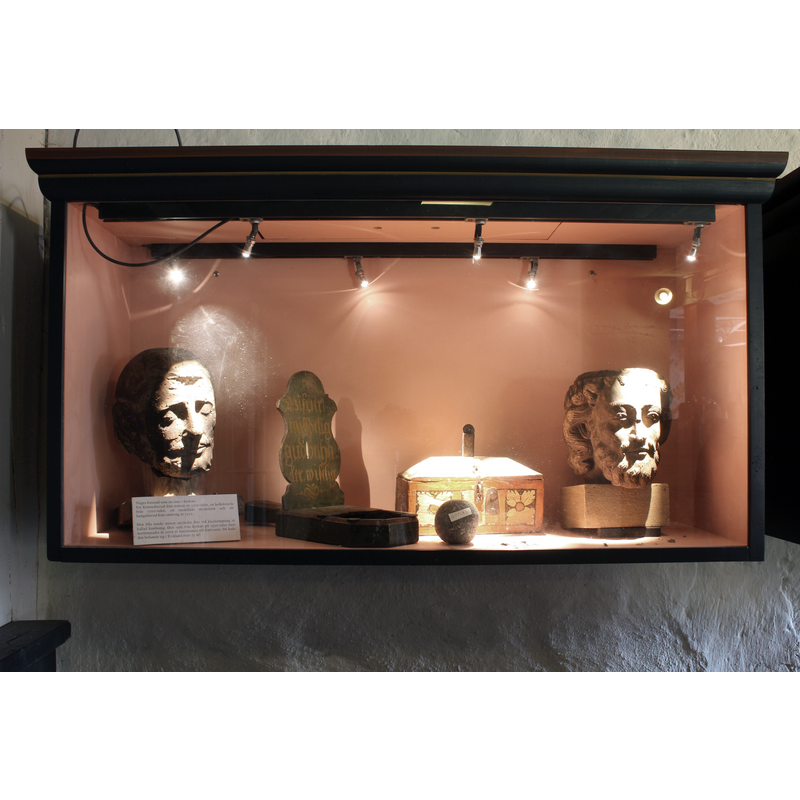 a display case containing an assortment of remains from the old church