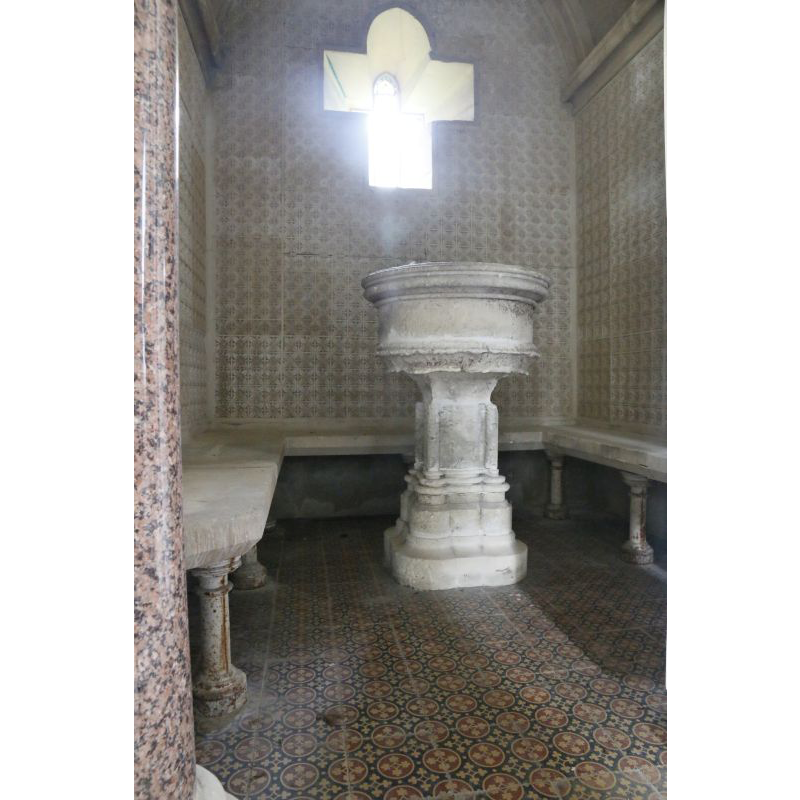 "Placed in the vestibule is 'an ancient font of stone, standing on four plain pillars, its sides rudely sculptured with something like an arabesque pattern of surrounding foliage' — such is the description recorded by John Duthy in the early 19th century after his visit to the old church in a meadow adjoining Water Lane where he saw the font. It is some three feet high and somewhat weather-beaten. Having been found in pieces in the present churchyard hedge where it had been dumped many years previously, it was reassembled by a recent vicar, the Revd. H. L. Atkins." [cf. FontNotes]
