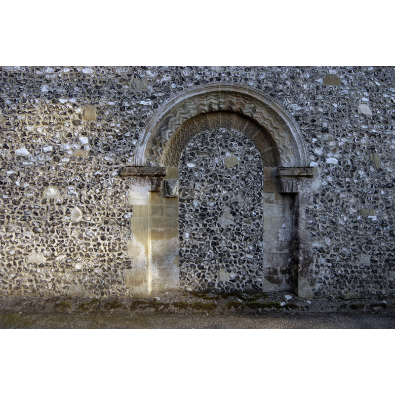 Source caption: "filled in Norman northern doorway of St. Mary's church, Kingsclere, Hampshire. Flint added in C19th."
