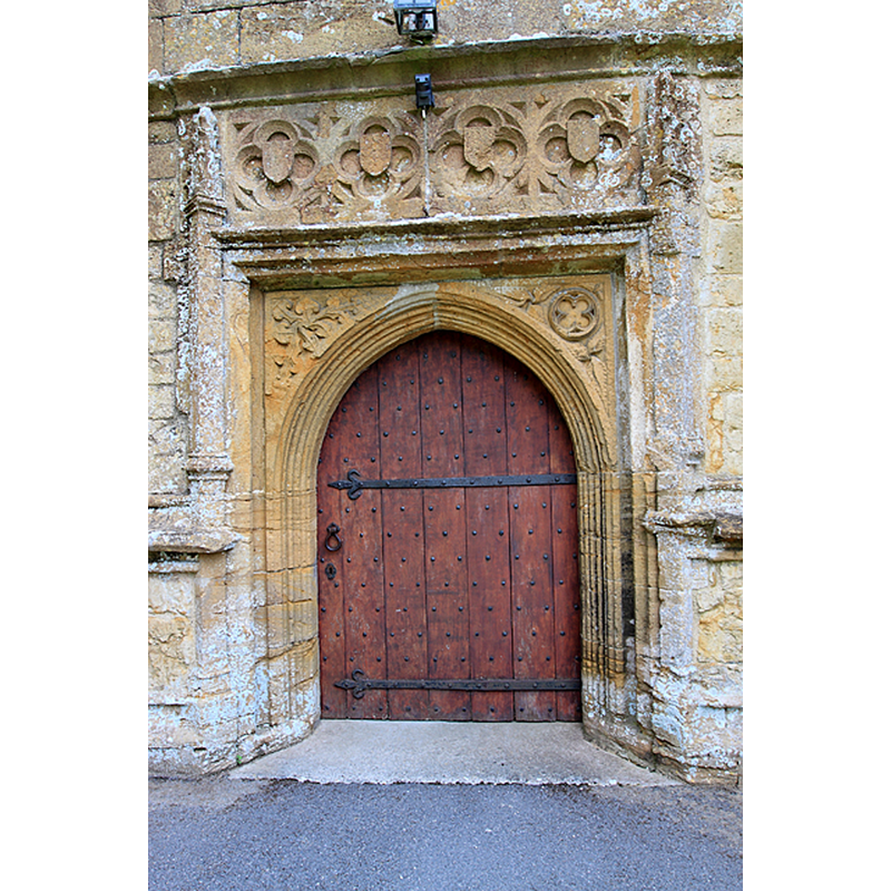 Source caption: "Whitchurch Canonicorum: Parish Church of St Candida and Holy Cross [west door detail] West door at the base of the tower with its heavily decorated surrounds.