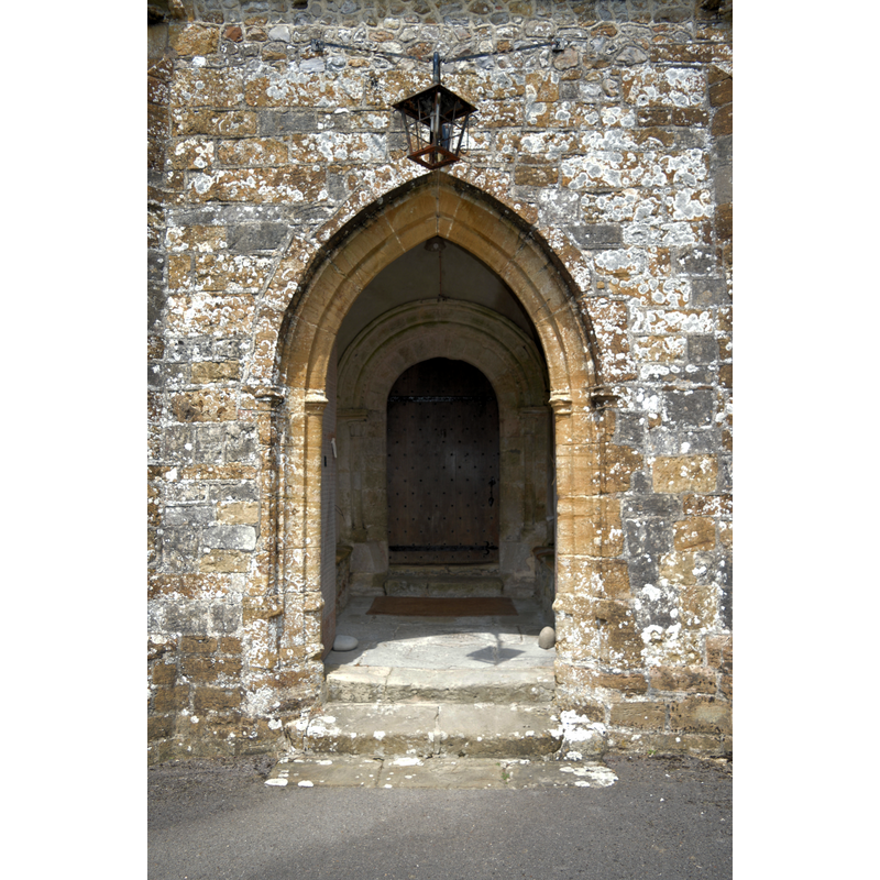 Source caption: "St Candida and Holy Cross, Whitchurch Canonicorum. The South porch, which shows the Norman origin of this fine building." [NB: the portal, inside, not the porch, is late-Norman]