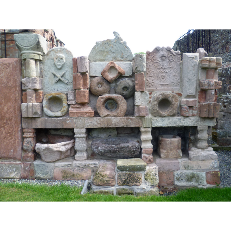 Source caption: "The Lapidarium, Coldingham Priory. What an inspired idea to take fragmentary relics of the destroyed Priory and transform them into a work of art. It looks so modern, yet it is a 19thC creation." -- are there any fonts or stoups in it?