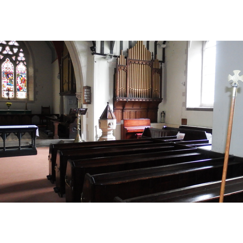 the modern font and cover in the modern church, ar the southeast corner of the nave