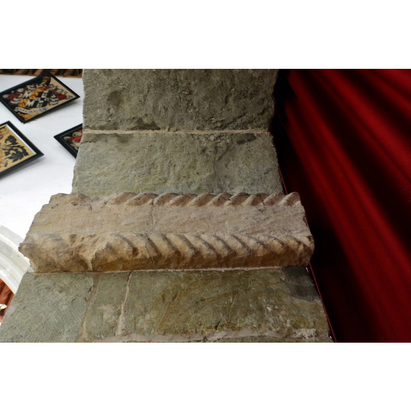 Source caption: "Breamore, St. Mary's Church: The Anglo Saxon south porticus door with an inscription over 1,000 years old. The pink stone running through the arch with its rough cable moulding."