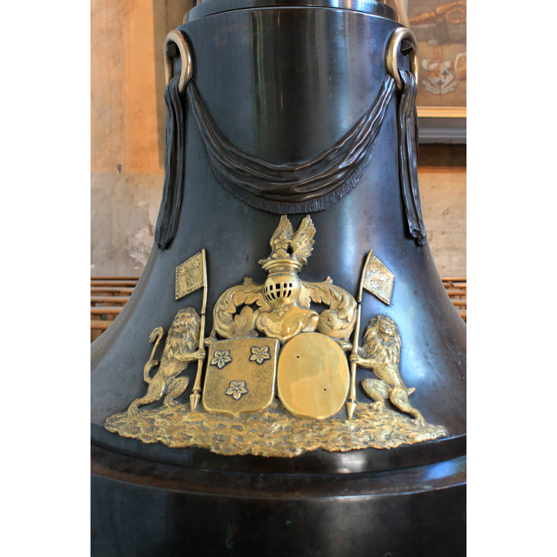 armorial device missing part of the right shield device -- the 18thC (?) font and cover